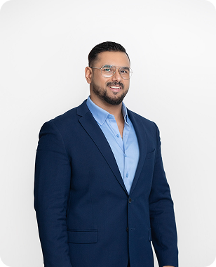 Executive headshot of a man in a navy suit
