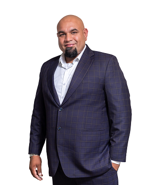 Executive headshot of a man in a checked suit